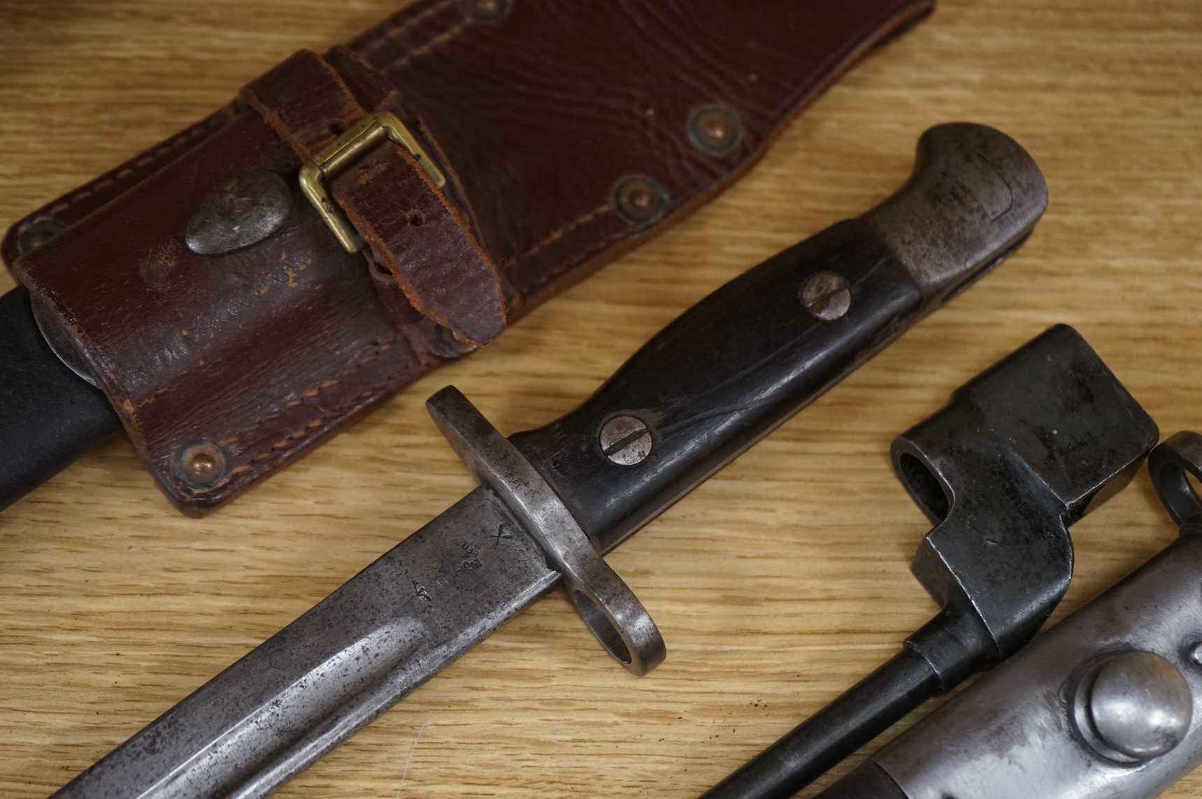 A 1907 bayonet by Wilkinson in its steel mounted leather scabbard, another similar with leather frog, two small British bayonets, a Continental bayonet, and two assorted hunting knives (7)